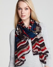 With a tribal print in seasonal hues and a bold striped border, this Theodora & Callum oblong scarf is a work of art.