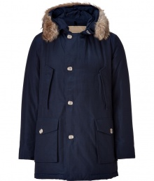 Stylish and sporty, this enamel blue down filled Arctic parka from the American heritage label Woolrich is a top choice for your contemporary outerwear wardrobe - Coyote fur trimmed hood, long sleeves, fitted ribbed knit cuffs, hidden front zip, button panel, buttoned flap and front slit pockets - Exceptionally warm, can be worn in temperatures as low as -30 F, washable cotton, water and snow resistant - Tapers slightly at waist, hits at mid-thigh - A versatile, classic coat perfect for both city streets and country slopes