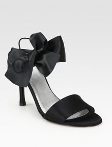 Glimmering satin with an oversized bow, elastic slingback strap and skinny heel. Self-covered heel, 4 (100mm)Satin upperLeather lining and solePadded insoleImportedOUR FIT MODEL RECOMMENDS ordering true size. 