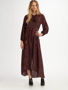 Flowing and free-spirited, this breezy silhouette of paisley-print silk evokes bohemian charm.Jewel necklineRuffled yokeButton-down placketGathered sleevesAsymmetrical hemAbout 35½ from natural waistSilkDry cleanImported