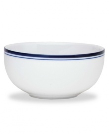 Named for a trendy Copenhagen neighborhood but designed with timeless style, the Christianshavn Blue cereal bowl features a double band of navy in pristine white porcelain. From Dansk.