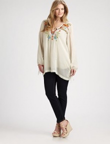 Featuring incredible embroidered details, this airy tunic offers a relaxed fit that you will love. Self-tie necklineLong sleevesStunning embroidery on front and backBack yokePull-on styleAbout 34 from shoulder to hemRayonMachine washImported