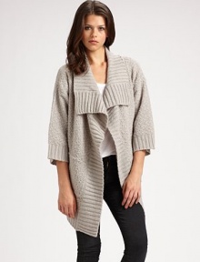 Comfy, textured design with a cropped back hem, shawl collar and bow-tie stitching. Shawl collar Open front Three-quarter sleeves Cropped back hem 85% acrylic/15% nylon Hand wash Imported