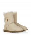 A stylish twist on a venerable classic, the Ugg Australia sand Bailey Button boot is a welcome addition to your cold weather casual wardrobe - Crafted from twin-faced sheepskin and featuring exposed seams, reinforced heel, traction outsole and signature Ugg label - Wooden button and elastic band closure - Fleece-lined for superior warmth and comfort - Traditional mid-calf height - Truly versatile, perfect for pairing with everything from skinny jeans to yoga pants to miniskirts