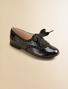 This lustrous patent leather style combines elegance and fun, with dotted trim, wingtip-look perforations and wide grosgrain ribbon laces that tie in pretty bows.Lace-up frontLeather upperLeather solePadded insoleImported