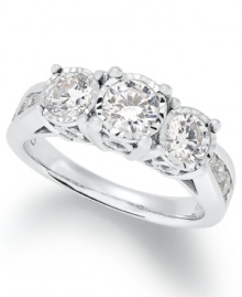 Give her the gift of forever. This stunning 3-stone ring features large round-cut diamonds (1-1/2 ct. t.w.) and smaller, channel-set diamonds in the band. Crafted in 14k white gold.