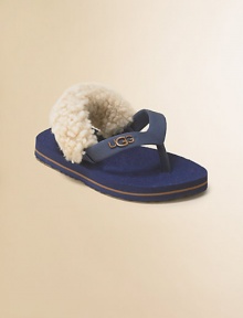 A cozy twist on the favorite flip flop, with a back strap lined in fluffy sheepskin to keep them on tiny feet.Rubber thong upperSheepskin-lined back strap with elastic tabsRubber soleRaised logo on thongImported