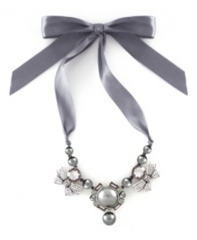 This satin ribbon necklace is as pretty as a gift-wrapped package. This elegant piece from the Jessica Simpson collection features gray glass pearls, beads, and crystals. Set in silvertone mixed metal. Approximate length: 17 inches. Approximate drop: 2 inches.