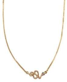 Biting style, from RACHEL Rachel Roy. This slinking necklace features a coiled snake decorated by glass stones and purple epoxy. Set in worn gold tone mixed metal. Approximate length: 16 inches + 2-inch extender.