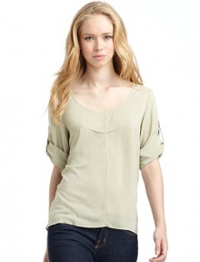 THE LOOKScoop necklinePullover styleThree-quarter length roll tab sleevesPleated detail on chestShirttail hemTHE FITAbout 25 from shoulder to longest point of hemTHE MATERIALViscoseCARE & ORIGINDry clean Made in USAModel shown is 5'10 (178cm) wearing US size 4.