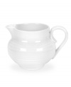 A collaboration between Portmeirion and celebrated chef Sophie Conran, this versatile creamer from their collection of white dinnerware offers the charming look of hand-thrown pottery in porcelain designed for the rigors of daily use.