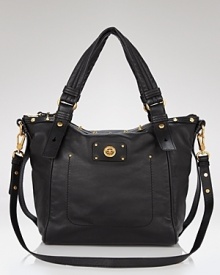 MARC BY MARC JACOBS updates the signature leather turnlock tote with subtle studded detailing for an added dose of cool.