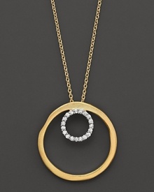 A diamond circle within a larger gold circle pendant. Designed by Meira T.