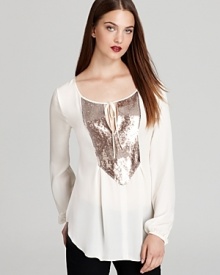 A simply irresistible Madison Marcus top makes its way to you flaunting shimmering sequins at the bib and delicate ties at the neckline. Slip into this chic piece with your favorite distressed jeans for the perfect juxtaposition.