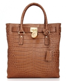 A classic design with exotic appeal, this exquisite tote from MICHAEL Michael Kors is the ultimate accessory. Croc-embossed leather and gleaming golden hardware lend a luxe look, while the spacious, pocket-lined interior keeps essentials safe and secure.