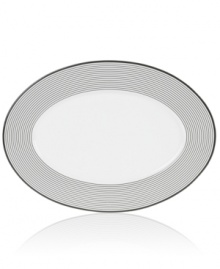 Have fun with the graphic rings and serious durability of Mikasa's Cheers oval platter. Bone china in black and white caters modern tables with a sense of whimsy.