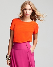 A sherbet-inspired hue invigorates a luxe silk short-sleeved Tory Burch silk top. Team over an equally vivid shade to create your own color blocked look.