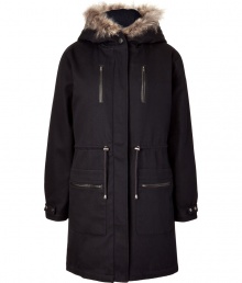 A traditional-style parka gets a modern update with clean lines and fur trim - Features a raccoon fur-trimmed hood, hidden zip closure, drawstring waist, patch and slit pockets at the front - Long sleeves with adjustable snap cuffs for added warmth - Long length for a season of comfort on the coldest days - Pair with slim jeans and favorite knee-high boots