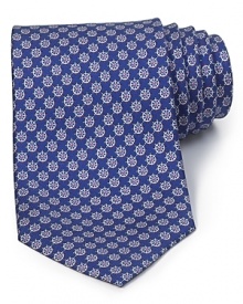 A luxurious piece that lies at the center of your dress wardrobe, this handsome tie from Salvatore Ferragamo is crafted in 100% Italian silk.