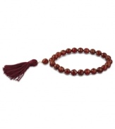 Totally on trend! Tassels are the thing this season, and this crimson-colored tassel and carnelian bead bracelet (109-3/8 ct. t.w.) completes the look. Set in 18k gold over sterling silver. Bracelet stretches to fit wrist. Approximate diameter: 2-1/4 inches. Approximate length: 7-1/2 inches.