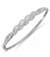 Subtly sparkling and precisely detailed, this elegant bracelet is boldly dramatic yet timeless. Crafted in sterling silver with round and baguette-cut diamonds (1 ct. t.w.). Approximate diameter: 2-1/2 inches.