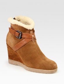 Urban-cool suede and leather essential, lined with shearling and heightened by a comfortable wedge. Suede-covered wedge, 3½ (90mm)Rubber platform, ½ (15mm)Compares to a 3 heel (75mm)Weatherproof suede and leather upper with faux shearling trimBack zip and adjustable leather strapFaux shearling liningSlip resistant rubber solePadded insoleMade in Italy