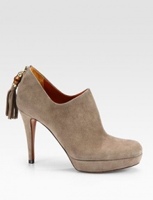 Suede ankle boots with bamboo and tassel details at the heel. Self-covered heel, 3½ (90mm) Platform, ¾ (20mm) Compares to a 2¾ heel (70mm) Shaft, 2 Bamboo tassel detail Back zip Leather lining and sole Padded insole Made in Italy 