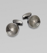 Concentric links of gunmetal-plated metal are polished on the outside and sandblasted in the recessed ridges to enhance the pattern. Gunmetal-plated metal About ½ diam. Made in the United Kingdom 