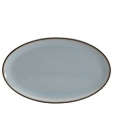 Handsome and understated, the Sienna oval platter features a glazed blue tint and mocha trim for smart-casual style with every entree.