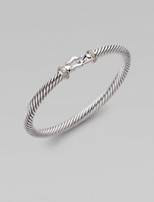 From the Cable Buckle Collection. A signature cable of sterling silver in a graceful bangle with a buckle clasp, accented with pavé diamonds. Diamonds, .10 tcw Sterling silver Cable, 5mm Diameter, about 2¼ Hook clasp Made in USA