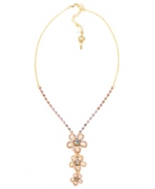 Petal perfection. Betsey Johnson's pretty three flower pendant features shimmering pink and purple crystals set in pave. Crafted in antique gold-plated mixed metal. Approximate length: 16 inches + 3-inch extender. Approximate drop: 2-1/2 inches.