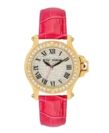 Glamour that packs a punch. Dare to wear this bold watch by Betsey Johnson. Pink croc-embossed leather strap and round gold tone stainless steel case. Bezel embellished with crystal accents. Crystal pave dial features black Roman numerals, black hour and minute hands, signature fuchsia second hand and logo. Quartz movement. Water resistant to 30 meters. Two-year limited warranty.