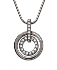 This classic pendant adds a touch of chic, modern style to any outfit. The dark sheen of the ruthenium tone mixed metal outer ring offsets the glitter of the inner circle with its clear Swarovski crystals set in pavé. Swarovski's Circle Pendant comes on a matching snake chain. Approximate length: 15 inches. Approximate drop: 7/8 inch.