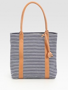 A canvas design with nautical-inspired stripes and chic leather handles. Double leather handles, 9 dropSnap closureThree inside pocketsFully linedCottonImported