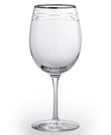 Commemorate a special anniversary with a simply elegant reminder of the time you said, I do. This radiant crystal wine glass is hand-engraved with interlocking bands that symbolize the rings exchanged between bride and groom. A platinum rim provides a graceful finish.