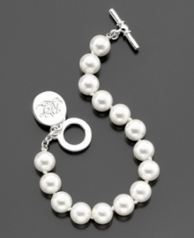 A stylish glass pearl (10 mm) toggle bracelet from Lauren Ralph Lauren with a cute logo charm. Length measures 8 inches.