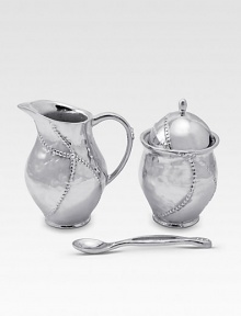 A handmade creamer and sugar set in hammered, sandcast aluminum, buffed by hand for unparalleled shine and elegance. Set includes sugar bowl with lid, creamer and matching spoon Creamer, 4½H X 3 diam. Sugar, 4½H X 3 diam. Spoon, 5 long Sandcast aluminum Food safe Hand wash Imported 