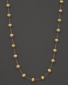 Textured bead stations lend bold style to this 18 karat gold necklace from Marco Bicego.