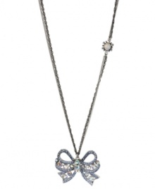 Take a bow. Betsey Johnson's silver tone mixed metal necklace features a sparkling bow pendant accented with clear and blue crystals, while a glass opal gem with crystal accents adorns the double silver tone chain. Approximate length: 32 inches + 3-inch extender. Approximate drop length: 1-3/4 inches. Approximate drop width: 2 inches.