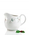 Create a serene winter scene with this festive motif from Pfaltzgraff. This gravy boat from the set of dinnerware and dishes has holly leaves and bright red berries that are accented with raised details and a green rim. Shown back right. (Clearance)