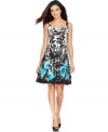 This pretty petite dress by Nine West features a classic A-line silhouette adorned with a black-and-white floral print and a bright-hued poppy print toward the hem.