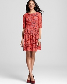 A contrast-colored lining peeks out through bright red lace on this season-less Shoshanna dress.