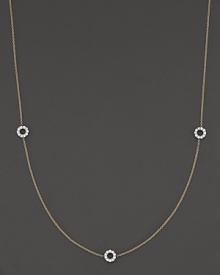 A delicate yellow gold chain with three double-sided white gold diamond circle stations.