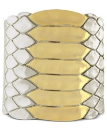 Coil your wrists with reptilian style. Vince Camuto's cuff bracelet features snake textured detail. Crafted in silver tone and gold tone mixed metal. Approximate length: 6 inches.