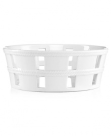 A bread basket woven of crisp white ceramic with embossed detail lends easy elegance to casual meals. From Martha Stewart Collection.