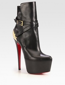 An exaggerated platform lifts this on-trend leather ankle boot, backed by a gleaming goldtone metal detail. Self-covered heel, 6¼ (160mm)Hidden platform, 2½ (65mm)Compares to a 3¾ heel (95mm)Leather and metal upperAdjustable buckle strapLeather liningSignature red leather solePadded insoleMade in Italy