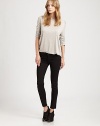 Perfect balance between modern and timeless, these highly chic skinnies have cropped-leg construction and shimmery tuxedo stripes on the sides. THE FITSkinny fitRise, about 8Inseam, about 27THE DETAILSButton closureZip flyFive-pocket style74% cotton/24% Tencel/2% LyocellDry cleanMade in USA of imported fabricModel shown is 5'10 (177cm) wearing US size 4.