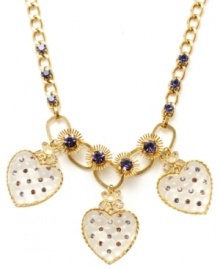 Love at first sight. Fashionistas everywhere will fall for Betsey Johnson's stylish statement necklace. With a trio of quilted heart charms, it's embellished with starburst accents, bows and colorful crystals. Made in gold tone mixed metal. Approximate length: 15 inches + 3-inch extender. Approximate drop: 2-1/2 inches.