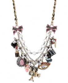 The reel deal. Betsey Johnson takes you to the movies with this frontal statement necklace. Crafted from gold-tone mixed metal and grosgrain ribbon, the necklace screams Action! with a number of glass accent charms. Approximate length: 16 inches + 3-inch extender. Approximate drop: 2-3/4 inches.