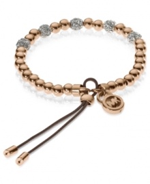 Add a little heat to your look. Michael Kors' stretchable bracelet combines rose-gold tone beads with pave crystal fireballs. Crafted in rose-gold tone mixed metal with an adjustable silk cord. Approximate diameter: 2-1/4 inches. Approximate width: 1/8 inch.